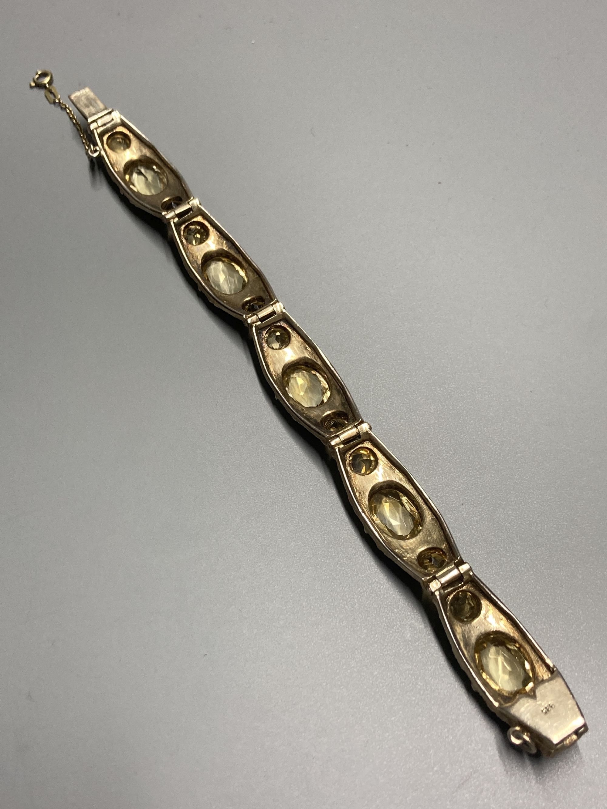 A continental 935 gilt metal and oval and round cut citrine and paste? set bracelet, approx. 16.5cm, gross 28 grams.